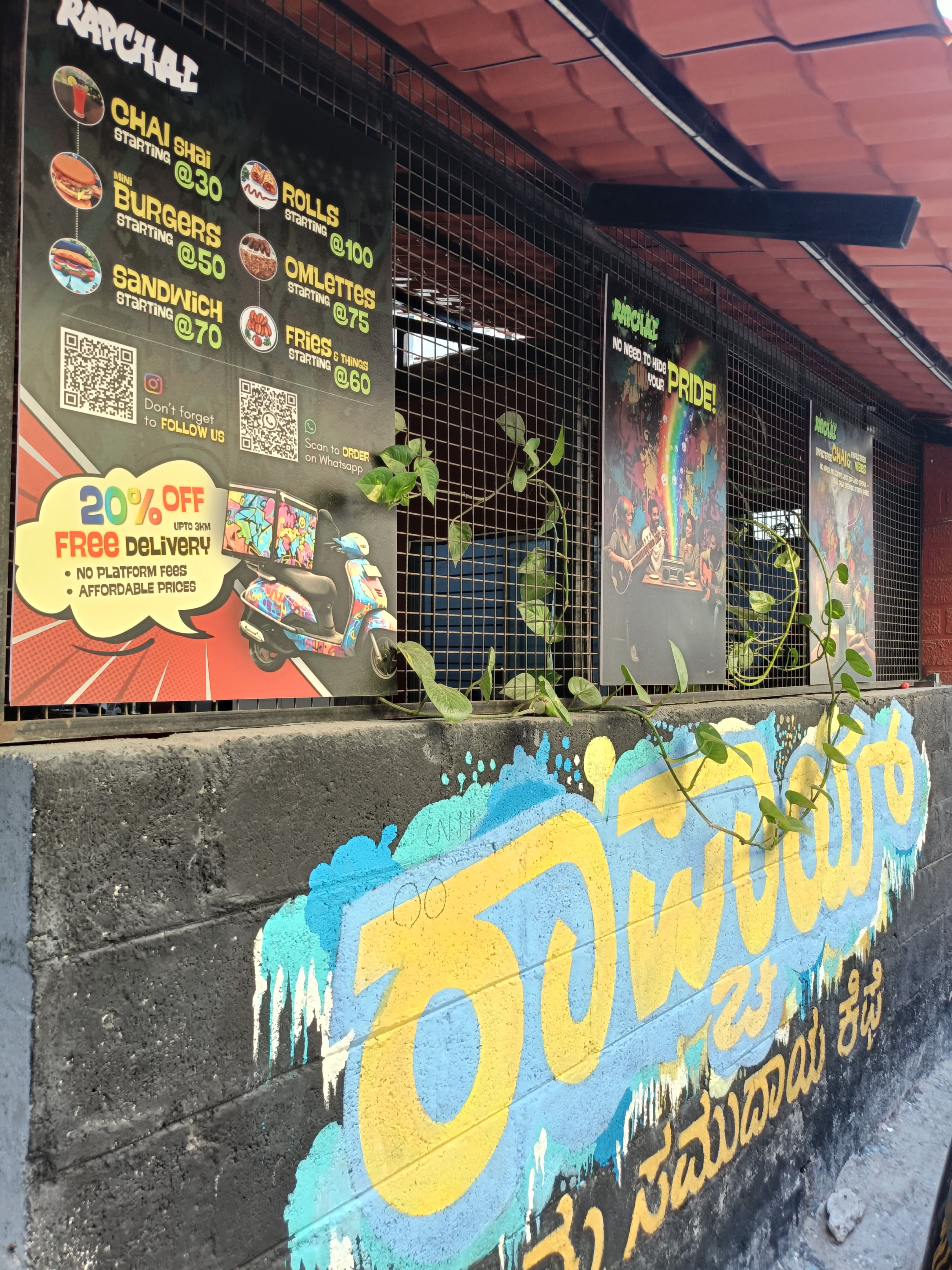 Rapchai exterior with Kannada graffiti and menu board