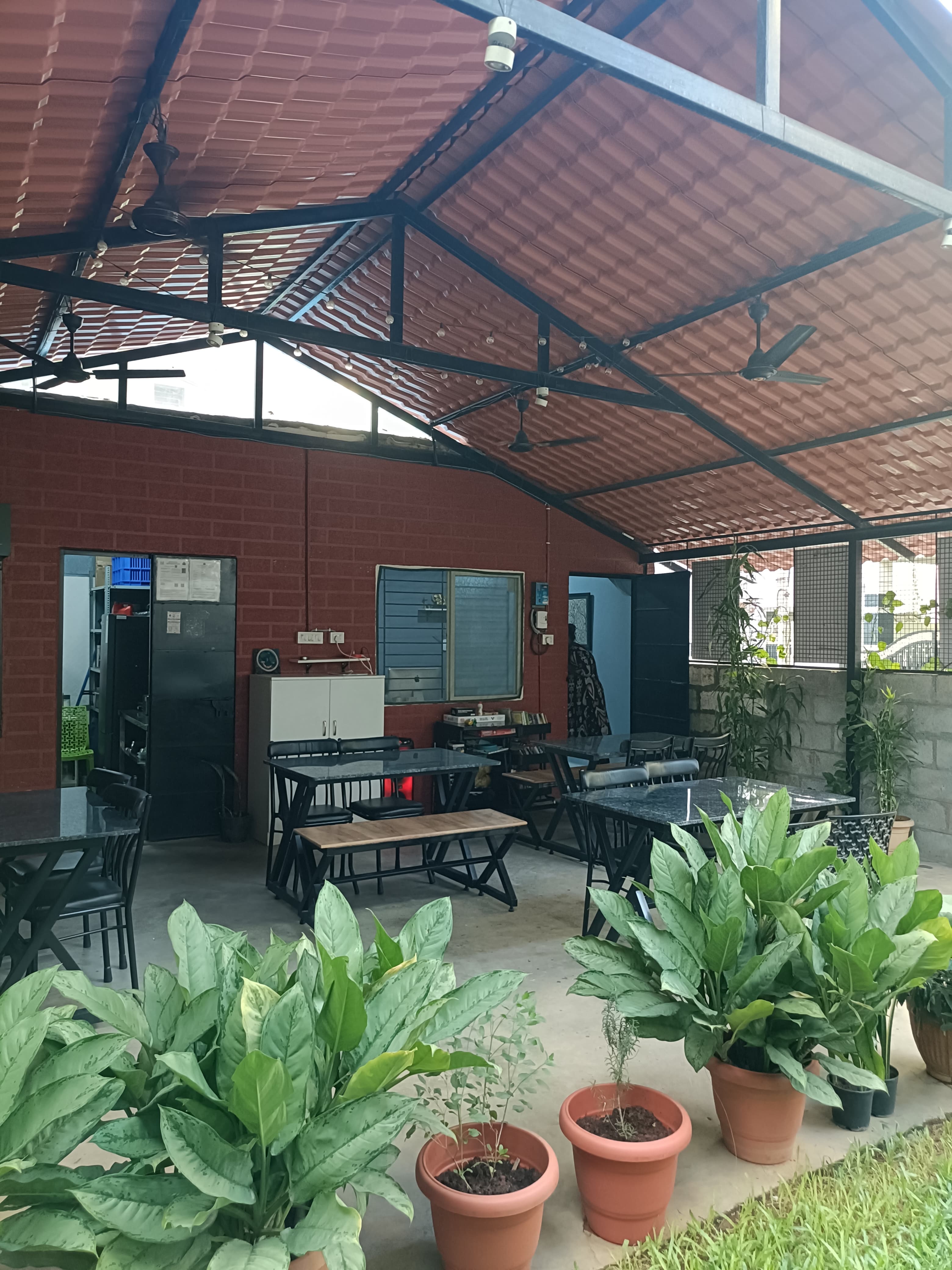 Rapchai open-air café seating under terracotta roof in Koramangala